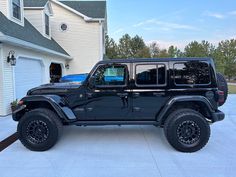a black jeep parked in front of a house