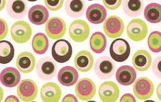 an image of colorful circles and dots on white fabric with pink, green, brown, and yellow colors