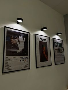 three black and white posters hanging on the wall