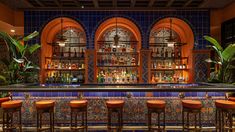 a bar with several stools in front of it