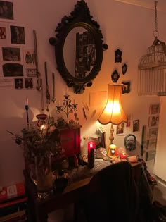 a living room filled with lots of furniture next to a wall covered in pictures and candles