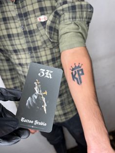 a man with a tattoo on his arm holding a card