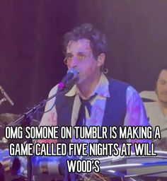 a man that is standing in front of a microphone