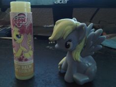 a little pony next to a tube of toothpaste