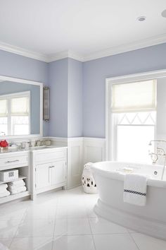a bathroom with blue walls and white fixtures