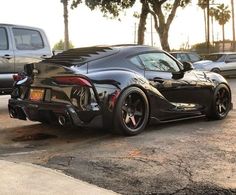 a black sports car parked in a parking lot