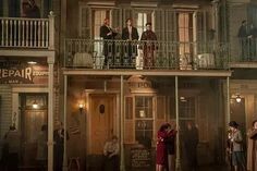 people standing on the balcony of a building at night