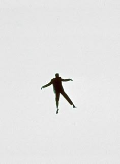 a person in the air with their arms outstretched