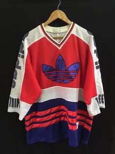 A personal favourite from my Etsy shop https://www.etsy.com/listing/271859678/sale-25-vintage-adidas-big-logo-jersey Rare Clothes, Vintage Tennis Outfit, 90s Adidas, Logo Jersey Design, Retro Hockey Jersey Style, Adidas Streetwear, Adidas Vintage Clothing 90s, Hockey Jersey Design, Three Stripes Jersey For Streetwear