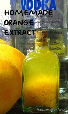 an orange sitting next to a glass bottle filled with liquid on top of a table