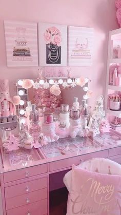 a pink desk topped with lots of drawers and lights next to a teddy bear pillow