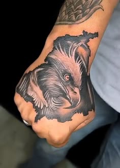 a man with a tattoo on his hand and an eagle in the middle of it