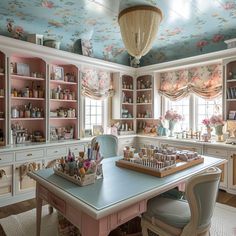a room with lots of furniture and walls covered in floral wallpaper on the ceiling