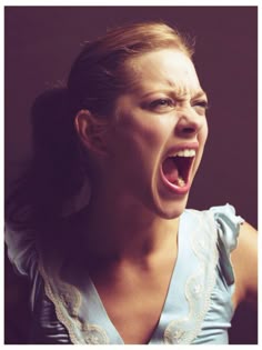 a woman with her mouth open and an angry look on her face