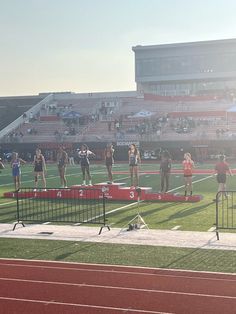 people are standing on the starting blocks at a track