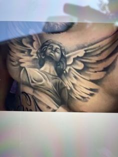 a man with an angel tattoo on his chest