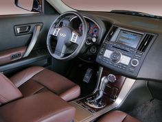 the interior of a car with brown leather seats