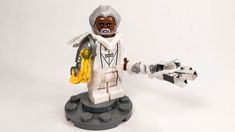 a lego figure holding a yellow object in his hand