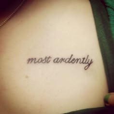 a woman's chest with the words most and only tattooed on her left side