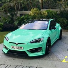 a green car parked in front of a building