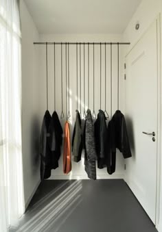 there is a coat rack with coats hanging from it