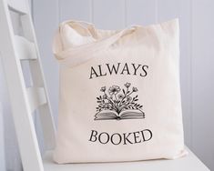 a book bag sitting on top of a white chair with the words always looked printed on it