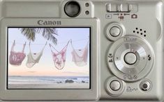 a digital camera with two pictures hanging from it's screen