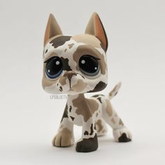a small toy dog with big eyes on a white background