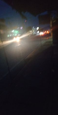 a car driving down a street at night