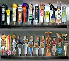 there are many different types of beer taps on the shelves in front of each other