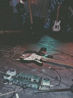 an electric guitar and other musical equipment on the ground