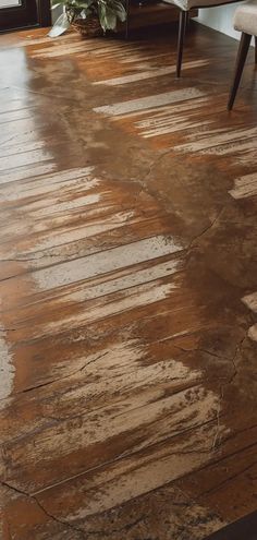 a living room with wood flooring and furniture on the other side of the room