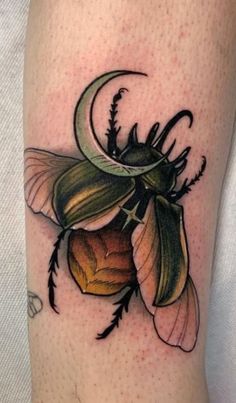 a tattoo on the leg of a person with a flower and moon in its center