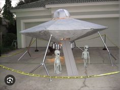 two alien statues in front of a house