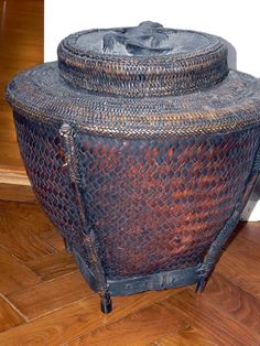 a large basket sitting on top of a wooden floor