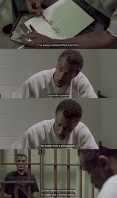 a man sitting at a table in front of a laptop computer and writing on paper