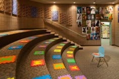 a room filled with lots of different colored pieces of art on the walls and floor