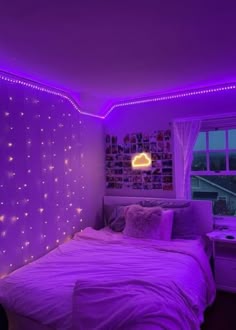 a bedroom with purple lights on the walls and a bed in front of a window