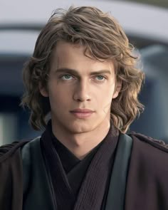 a young man with long hair wearing a star wars outfit and looking at the camera
