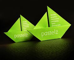 three green origami boats sitting on top of each other with the words pastelz printed on them