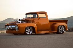 an orange truck parked on top of a parking lot