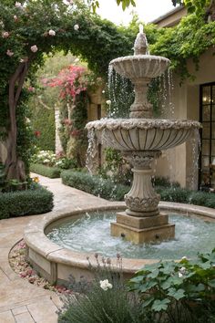 a water fountain in the middle of a garden