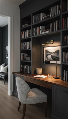 Moody library home office with dark cabinetry, built-in desk, and chair, with text overlay reading Cozy Home Office Layout: Dreamy Library Nook