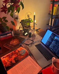 an open laptop computer sitting on top of a desk next to a cup of coffee