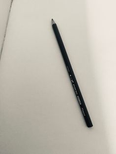 a pencil laying on top of a piece of paper