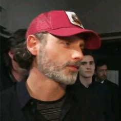 a man with a beard wearing a red hat