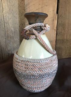 a white vase sitting on top of a table