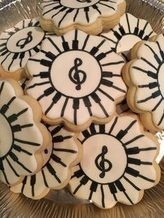 decorated cookies in the shape of piano keys and trebles on a platter