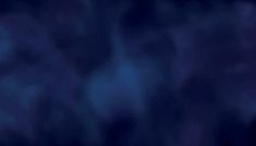 a blurry image of the sky and clouds in dark blue hues, as well as an orange light