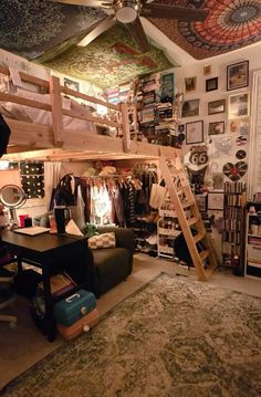 a loft bed with a ladder in the middle and lots of pictures on the wall